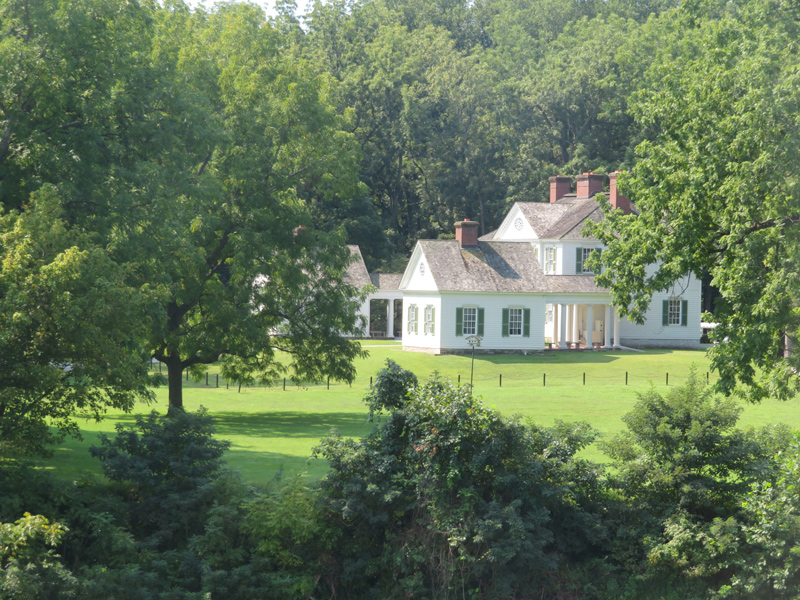 Large white house with two wings and a large lawn
