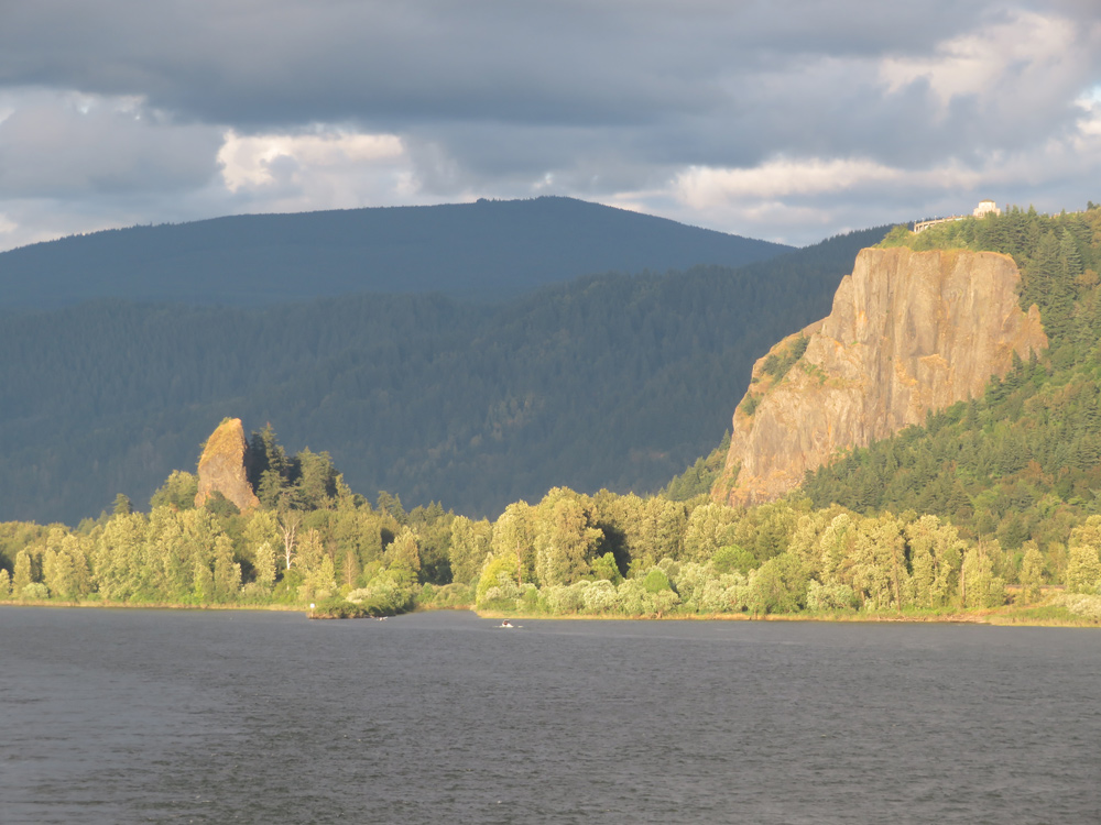 The sun lights up the basalt Crown Point and Rooster Rock