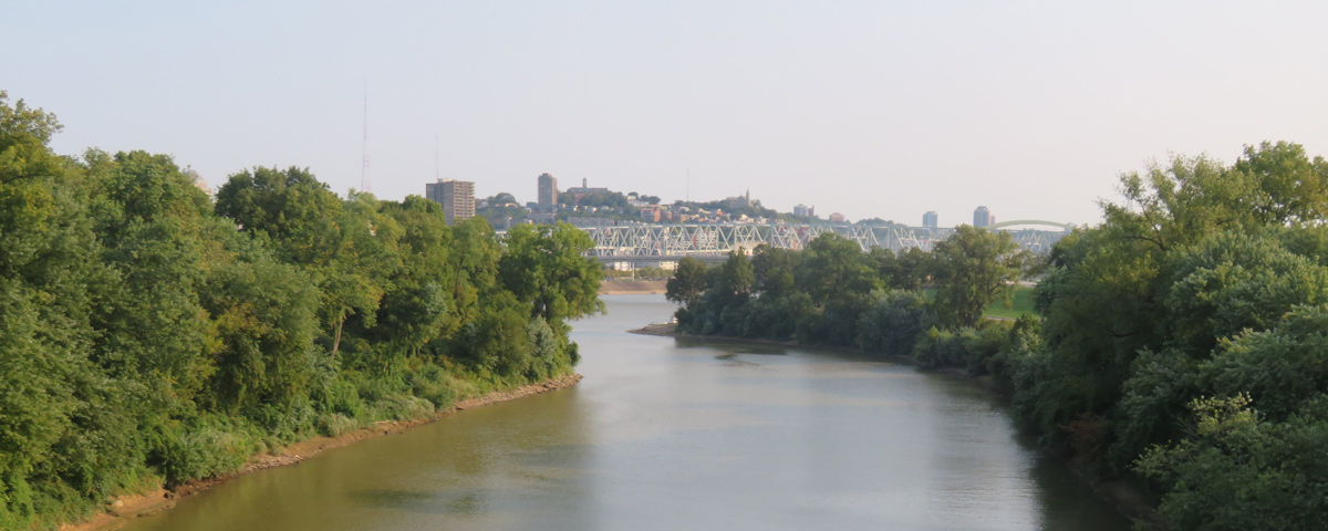 A small river enters the Ohio in front of the large city of Cincinnati