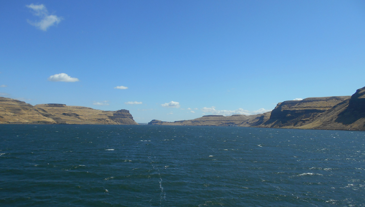 High brown hills surround the wide Columbia River