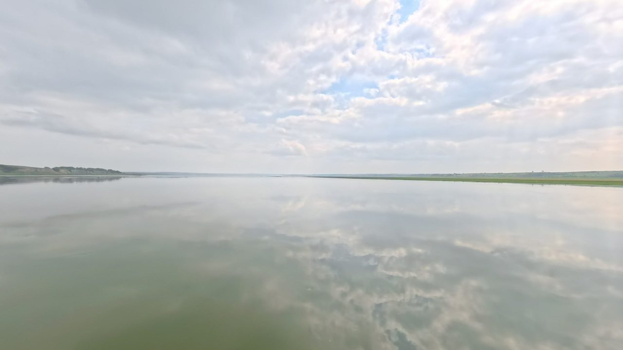 The calm Missouri River reflecting a sky full of clouds, 2025