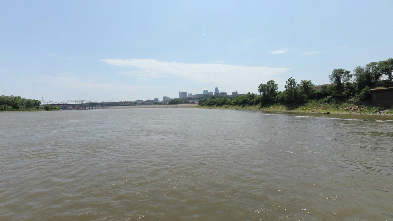 The Missouri River with a city skyline and bridges on the horizon, 2023